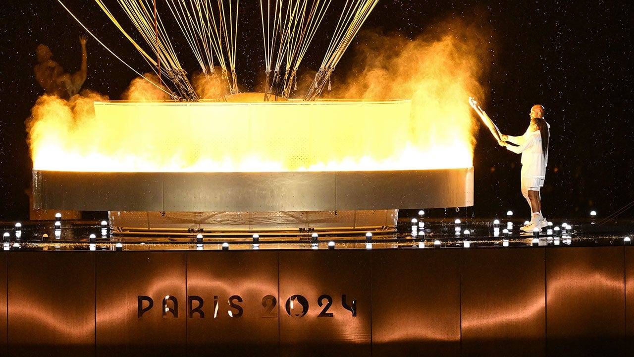 French Olympic heroes Marie-José Pérec, Teddy Riner light cauldron to kick off Paris games